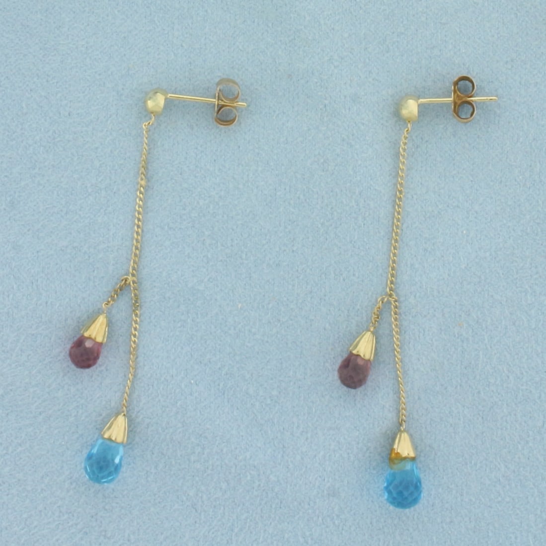 Amethyst and Blue Topaz Briolette Dangle Earrings in 10K Yellow Gold: In 10k yellow gold. 2 inches long. Contains 2 briolette Blue Topaz, 10x5mm each, and 2 briolette Amethyst, 7x4mm each, all with vibrant color and excellent clarity. Friction backs. 2.2g.