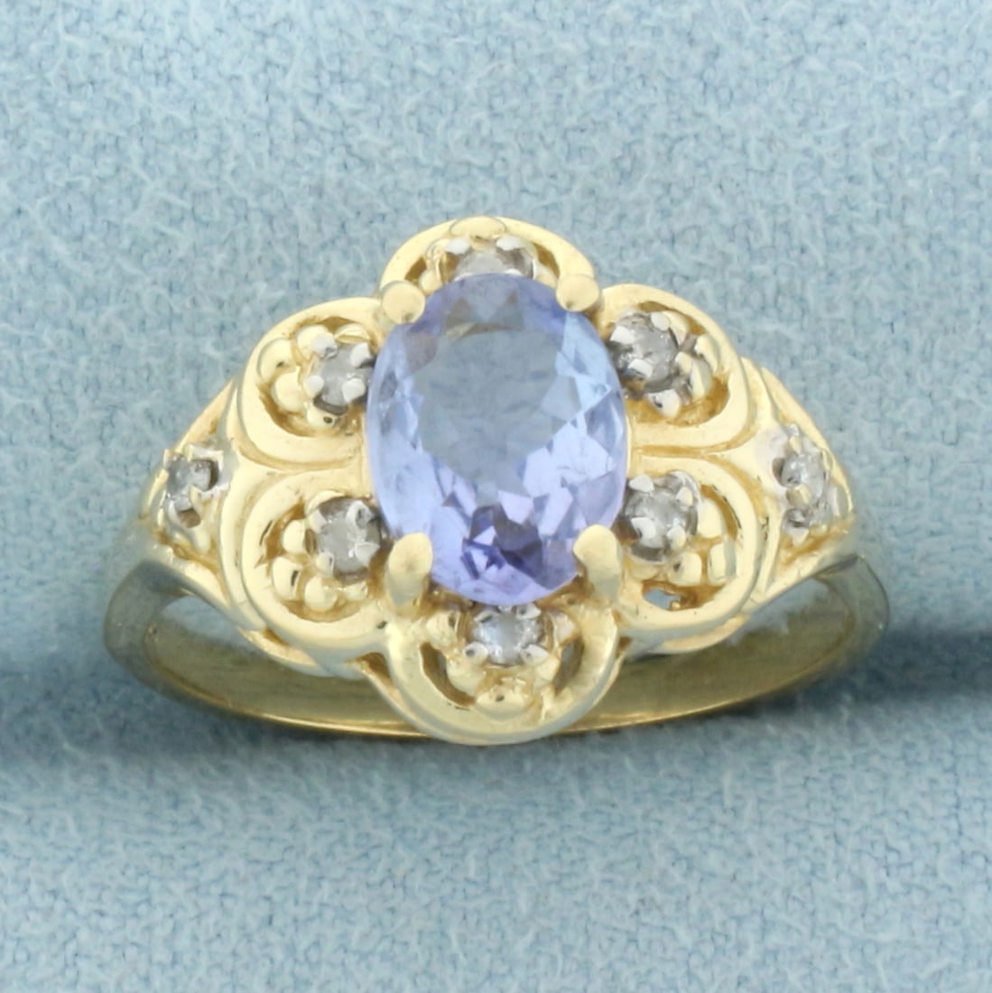 Tanzanite and Diamond Ring in 14k Yellow Gold: In 14k yellow gold. Contains one oval cut 8mmx6mm high quality Tanzanite gemstone, approximately 1.5ct, with vibrant color and excellent clarity. Accented by eight .01ct high quality diamonds, I color