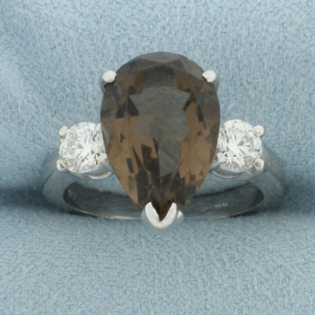 Smoky Quartz and Hearts on Fire Diamond Ring in 18k White Gold: In 18k white gold. Contains one 15 x 10mm pear cut smoky quartz gemstone, 4.5cts, with intense color and excellent clarity. Accented by 2 round brilliant "Hearts on Fire" diamonds (ideal cut), .6ct