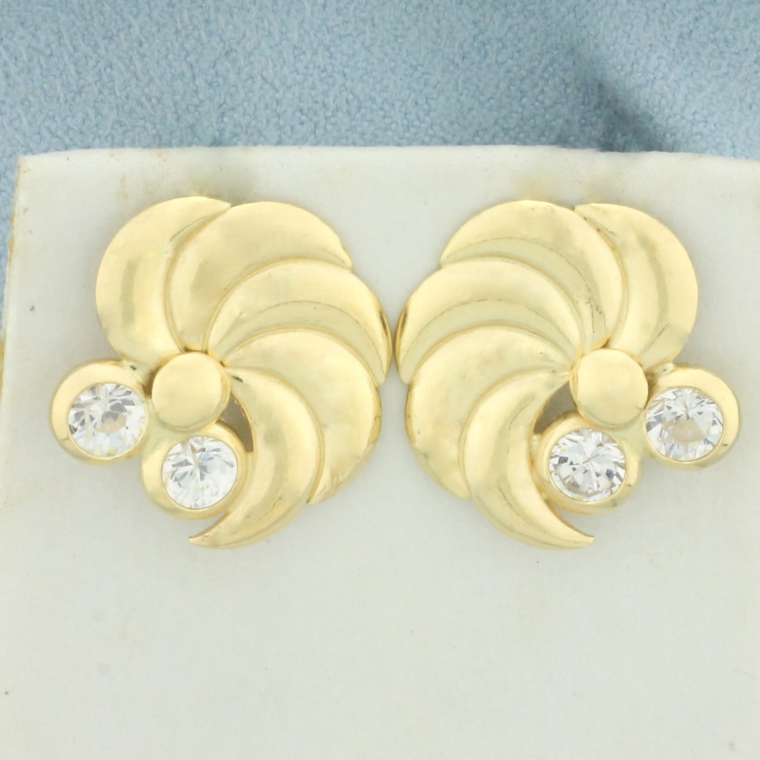Pinwheel Design CZ Earrings in 18k Yellow Gold: In 18k yellow gold. Contains four high quality 4.5mm high quality CZ gemstone with excellent cut and clarity for added sparkle. 3/4 inch wide. Friction backs. 4.6g.