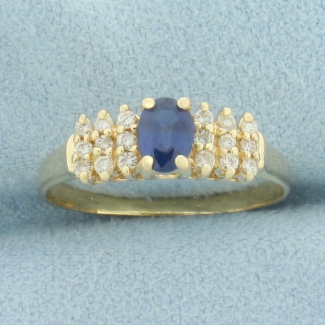 Sapphire and Diamond Ring in 14k Yellow Gold: In 14k yellow gold. Contains one high quality 6mm by 4mm Sapphire gemstone, 1/2ct, with vibrant color and excellent clarity. Also contains eighteen high quality .01ct diamonds, SI clarity/H color.