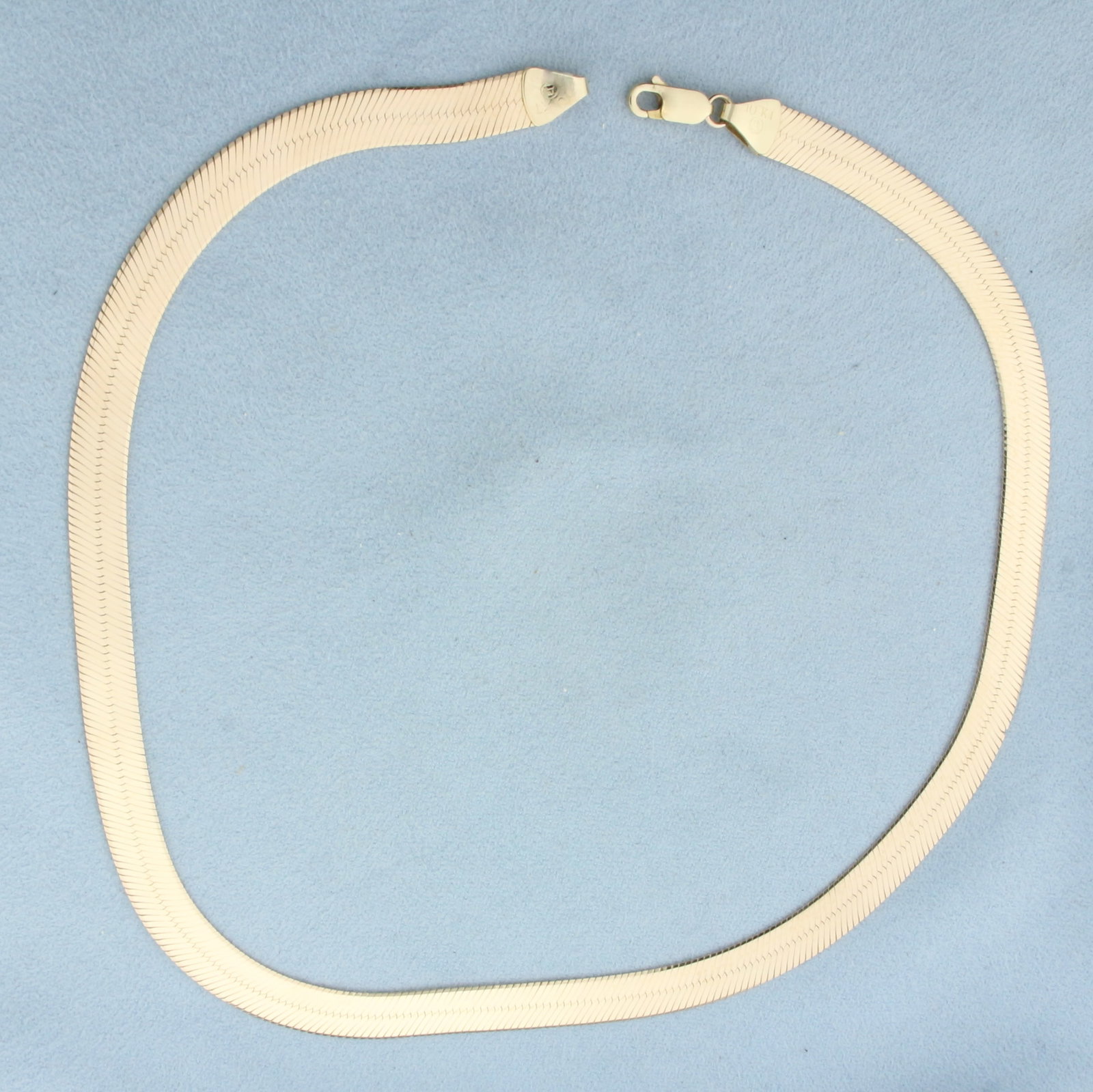 Italian 16 Inch Choker Herringbone Liquid Gold Chain Necklace in 10k Yellow Gold: In 10k Yellow Gold. 16 inches long. 7mm wide. Italian made. Lobster clasp. 16.9g.