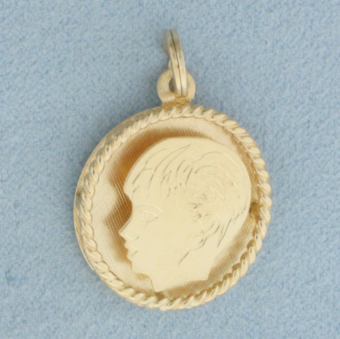 Engravable Boy Head Silhouette Charm or Pendant in 14k Yellow Gold: In 14k Yellow Gold. 1 1/8 inch long. 3/4 inch wide. Split ring for easy attachment. Blank back, can engrave name or date. 3.2g.