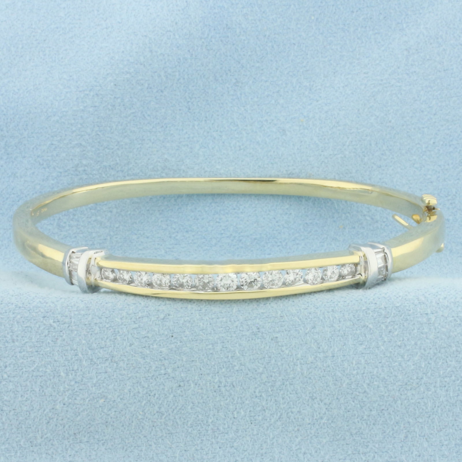Two Tone Diamond Bangle Bracelet in 14K Yellow and White Gold: In 14k yellow and white gold. Hinged style for easy on/off. Interior dimensions: 2.25 inches x 2 inches. Contains 13 round and 8 baguette high quality diamonds, 1ct TW, SI clarity/H color. Slide clasp