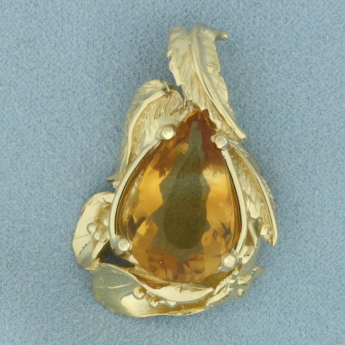 Citrine Butterfly Leaf and Flower Pendant in 14k Yellow Gold: In 14k yellow gold. 1 3/8 inches long by 1 inch wide. Contains 1 pear cut Citrine, 20x12mm, approximately 8cts, with intense color and excellent clarity. 14.3g.