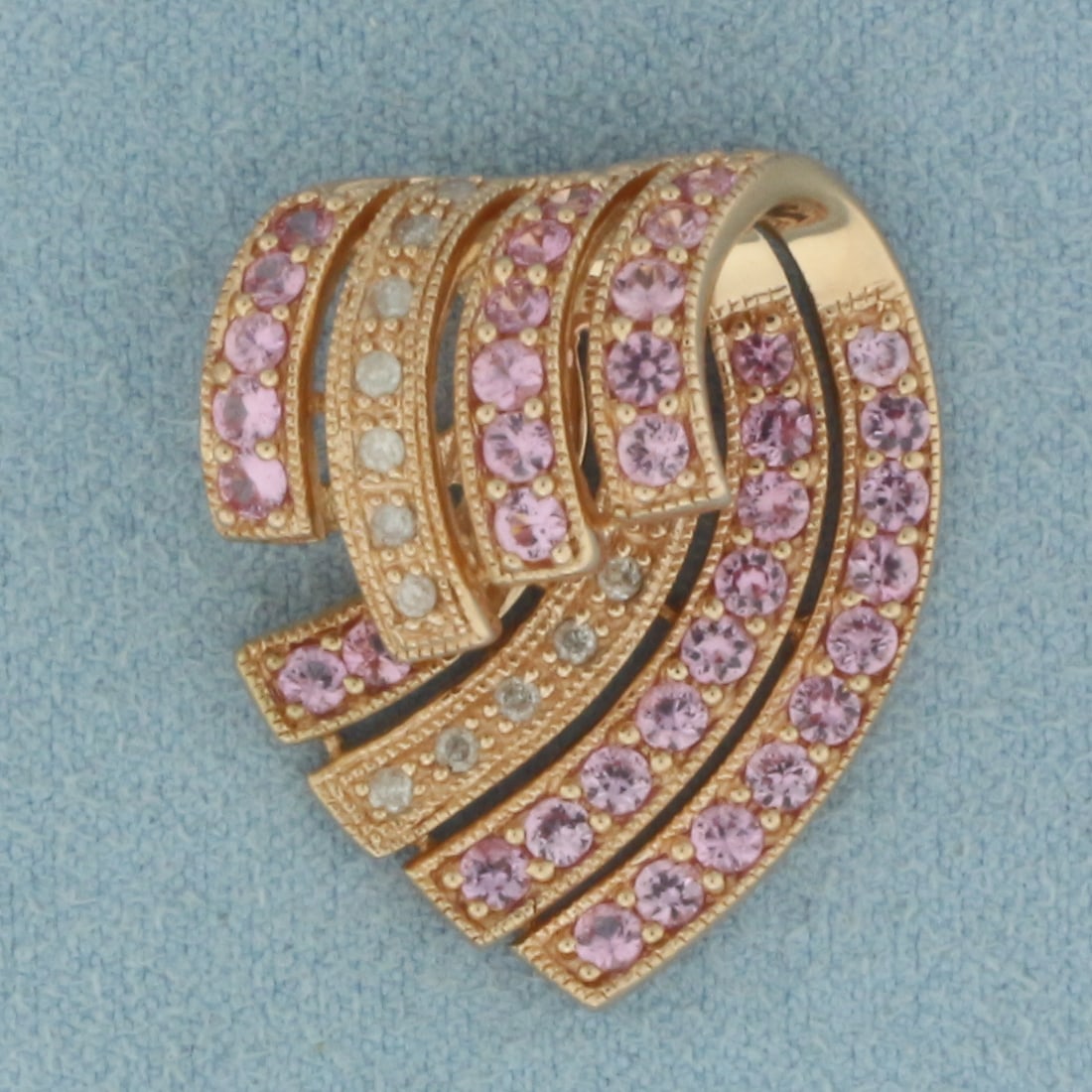 Pink Sapphire and Diamond Slide Pendant in 14K Rose Gold: In 14k rose gold. 1 inch long by 7/8 inch wide. Contains 13 high quality .01ct diamonds. Also contains 37 high quality 2mm Pink Sapphire gemstones with bright color and excellent clarity. 6.2g.