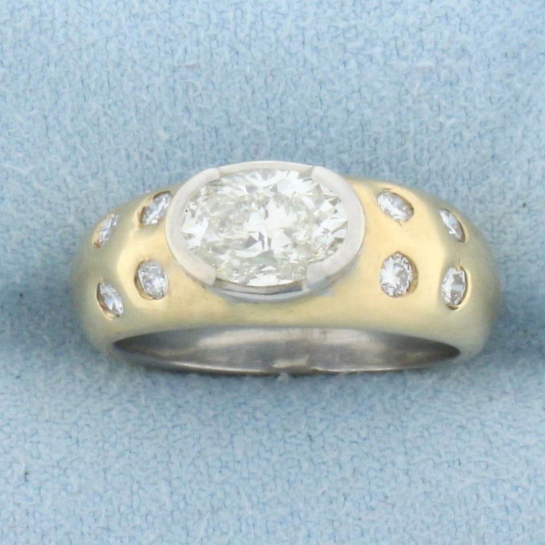 Designer Oval Diamond Engagement Ring in 14K Yellow and White Gold: In 14K Yellow and White Gold. Contains a center 1.2ct oval shaped high quality Diamond, VS clarity/K color, excellent cut for lots of sparkle. Also contains eight .04ct round Diamonds of similar high 
