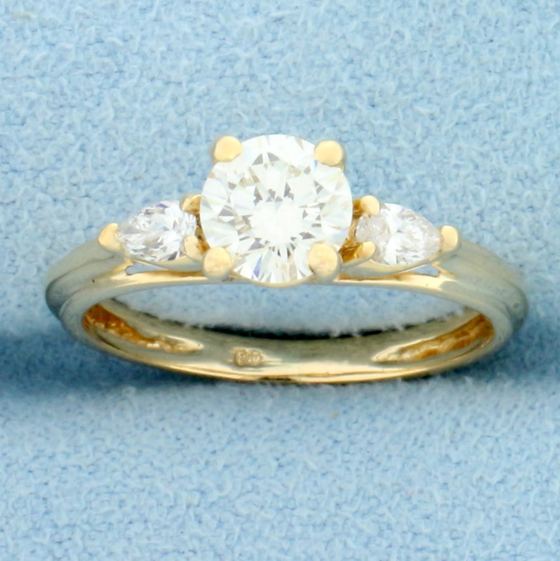 Round and Pear Diamond Engagement Ring in 14k Yellow Gold: 14K yellow gold. Center diamond is high quality 3/4ct round brilliant, VS clarity/H color, great cut for lots of sparkle. Also included two pear shaped diamonds, 1/4ct TW, of similar high quality. Siz