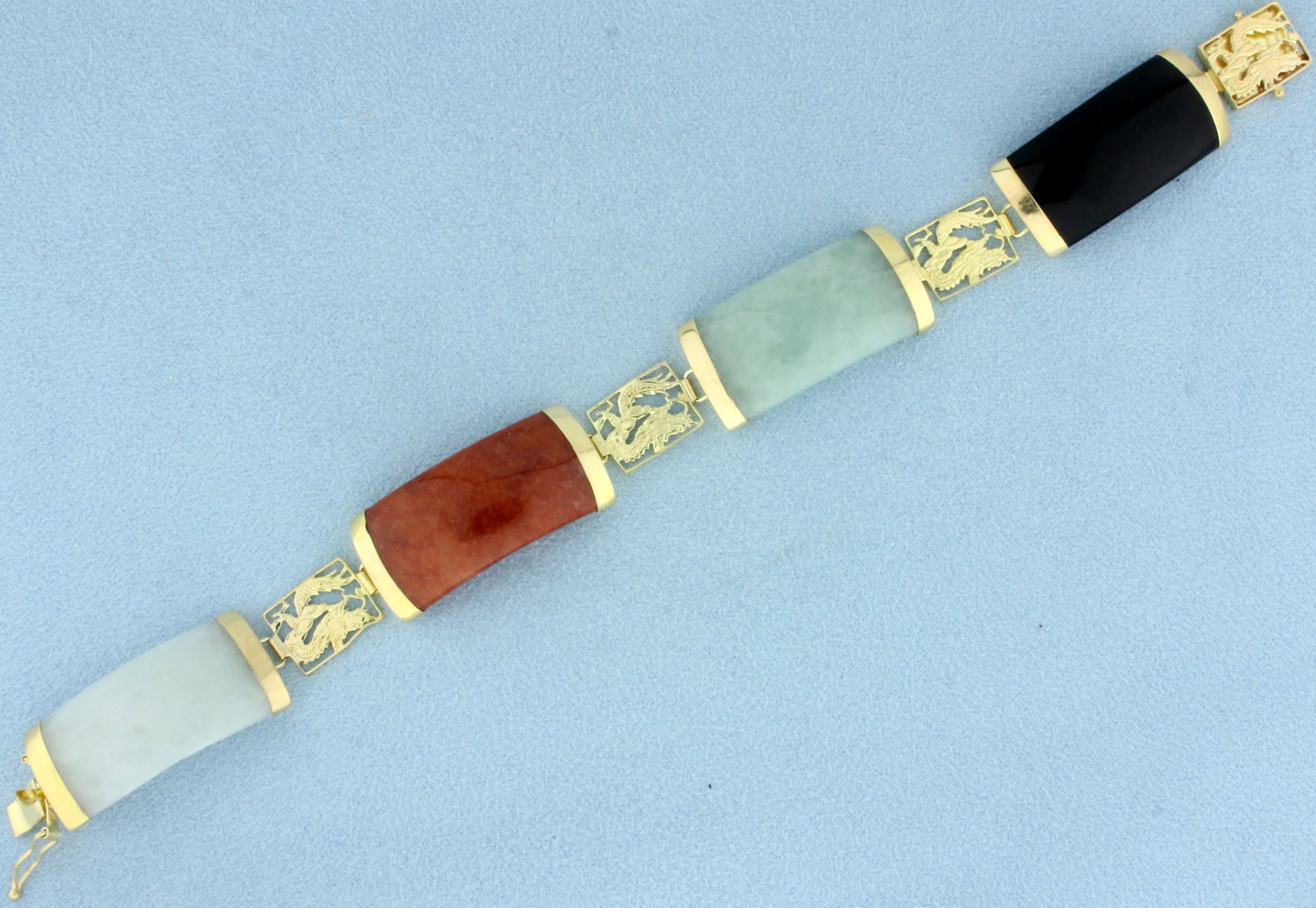 Multicolor Jade Dragon Bracelet in 14k Yellow Gold: In 14k yellow gold. Contains four 26mmx15mm high quality natural white, red, green, and black jade gemstones with vibrant color. 7.5 inches long. Safety clasp. 21.4g.