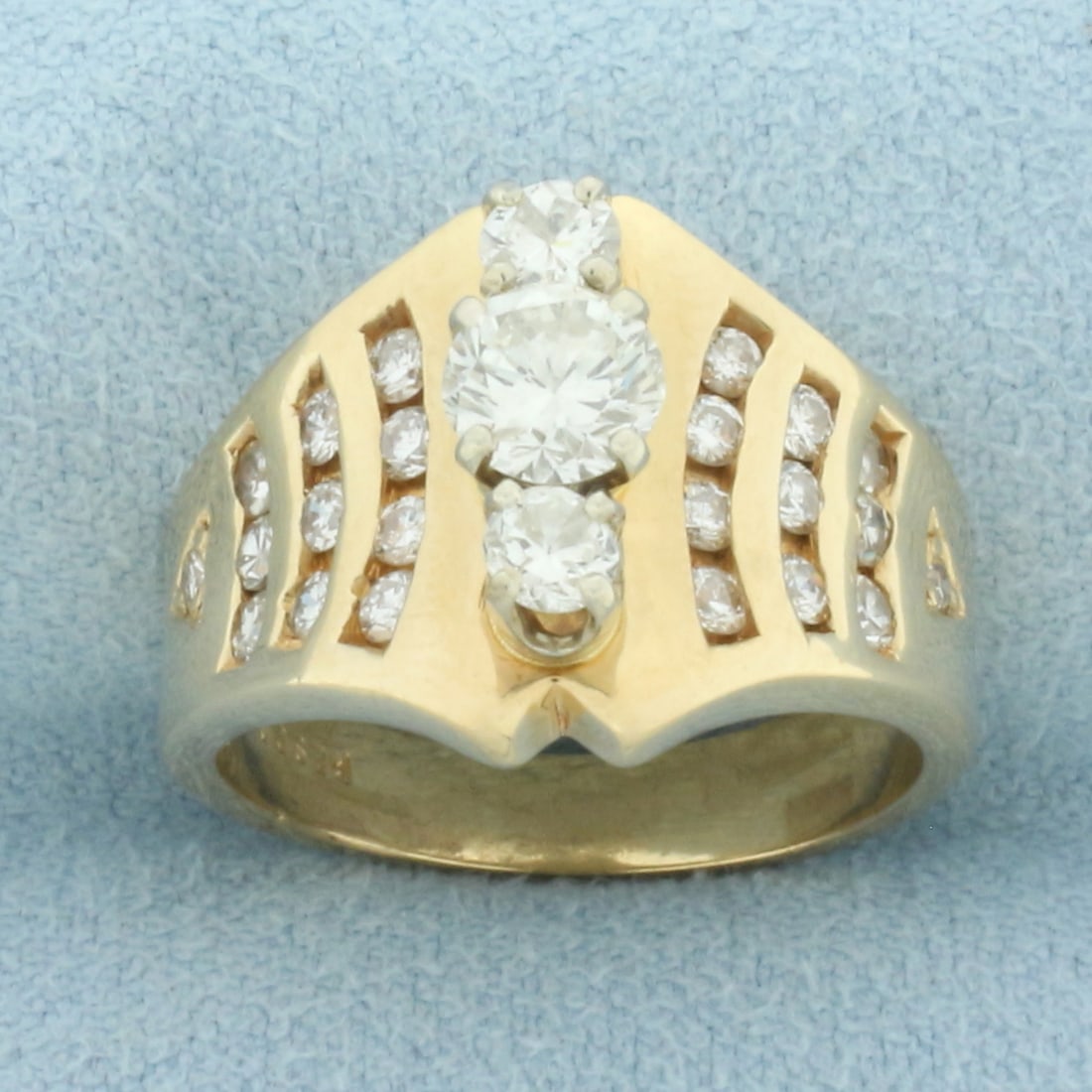 Vertical Diamond 3 Stone Ring in 14k Yellow Gold: In 14k yellow gold. Contains one 1/2ct and two 1/8ct high quality round brilliant diamonds, VS clarity/H color, great cut for lots of sparkle. Also contains twenty-two high quality diamonds channel se