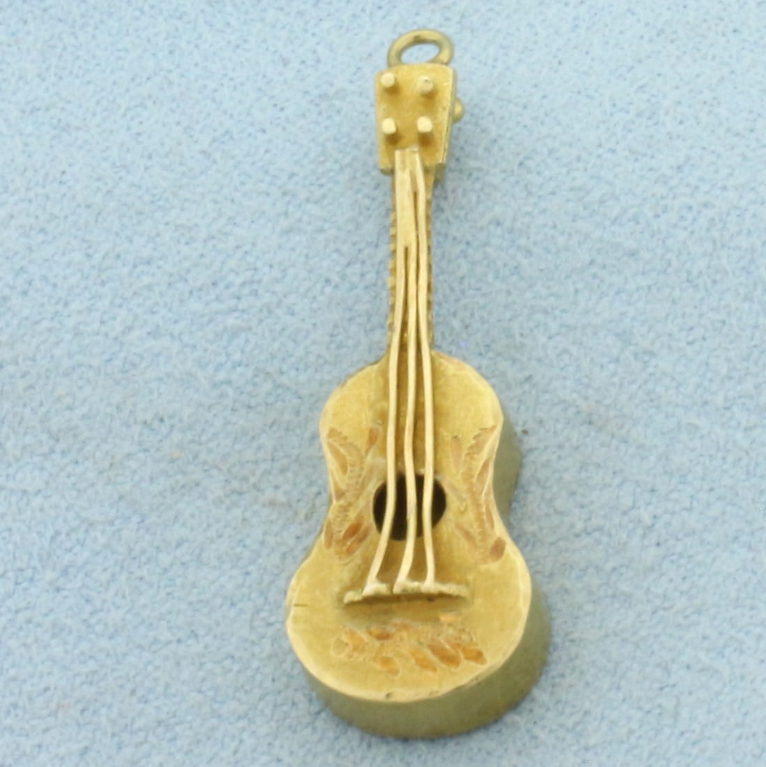 Acoustic Guitar Pendant in 18k Yellow Gold: In 18k Yellow Gold. 1 1/4 inches long. 3/8 inch wide. 3.5g.