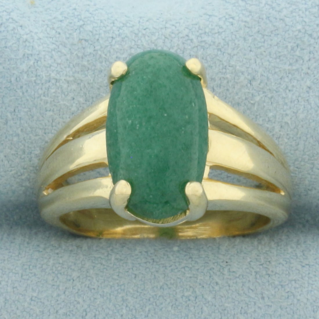 Jade Solitaire Statement Ring in 14k Yellow Gold: In 14k Yellow Gold. Contains one 15 by 9mm high quality natural Jade gemstone with beautiful emerald green color. Size 9.5. 9.8g.