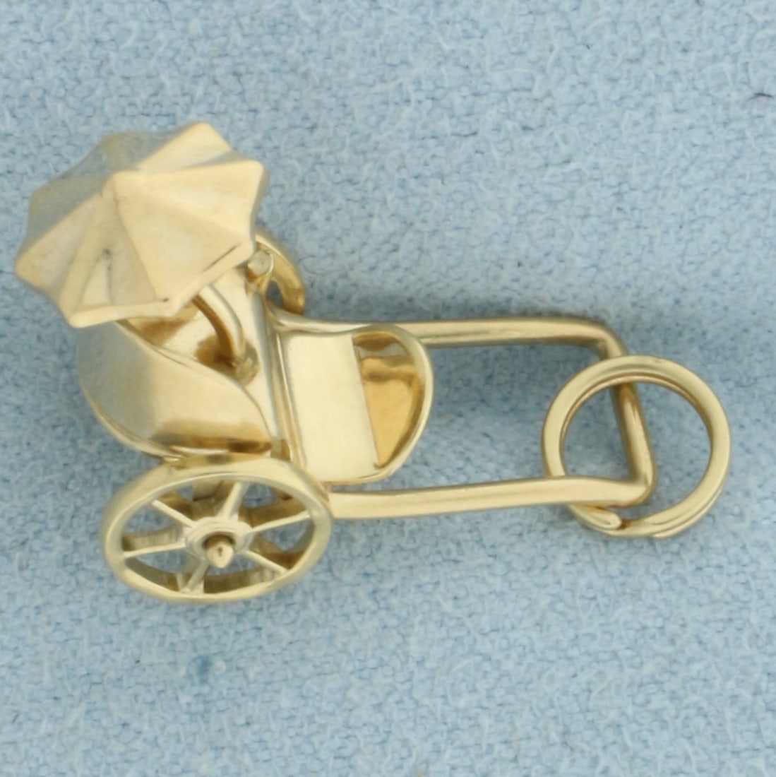 Rickshaw Carriage Charm or Pendant in 14k Yellow Gold: In 14k Yellow Gold. 1/2 inch long. 3/8 inch wide. Spinning wheels. 2.7g.