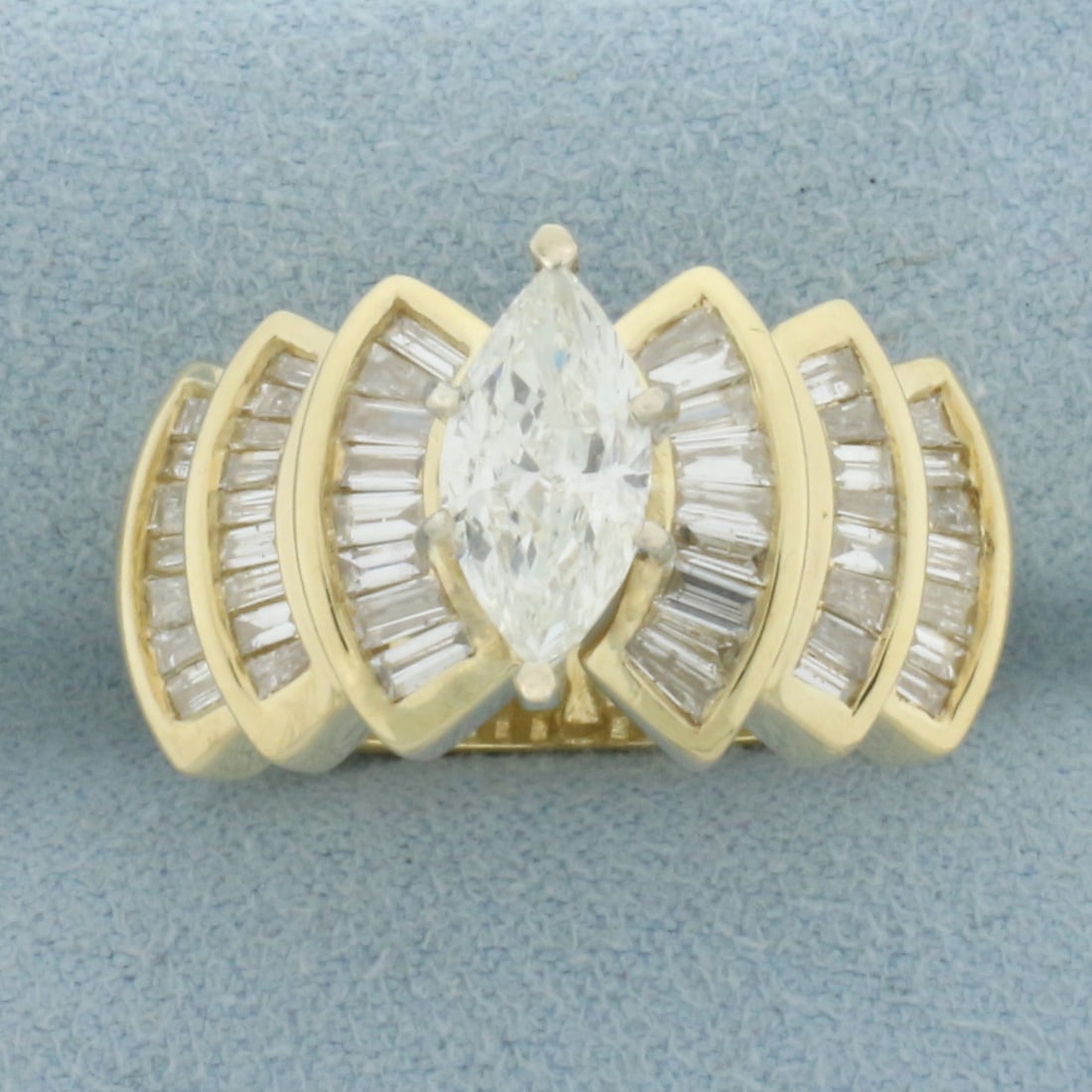 Marquise and Baguette Diamond Engagement Ring in 14k Yellow Gold: In 14k Yellow Gold. Contains one 11 by 5.25mm marquise diamond, approximately 1ct, I color/I1 clarity, eye clean, great cut for added brilliance. Also contains forty-eight baguette high quality diamon