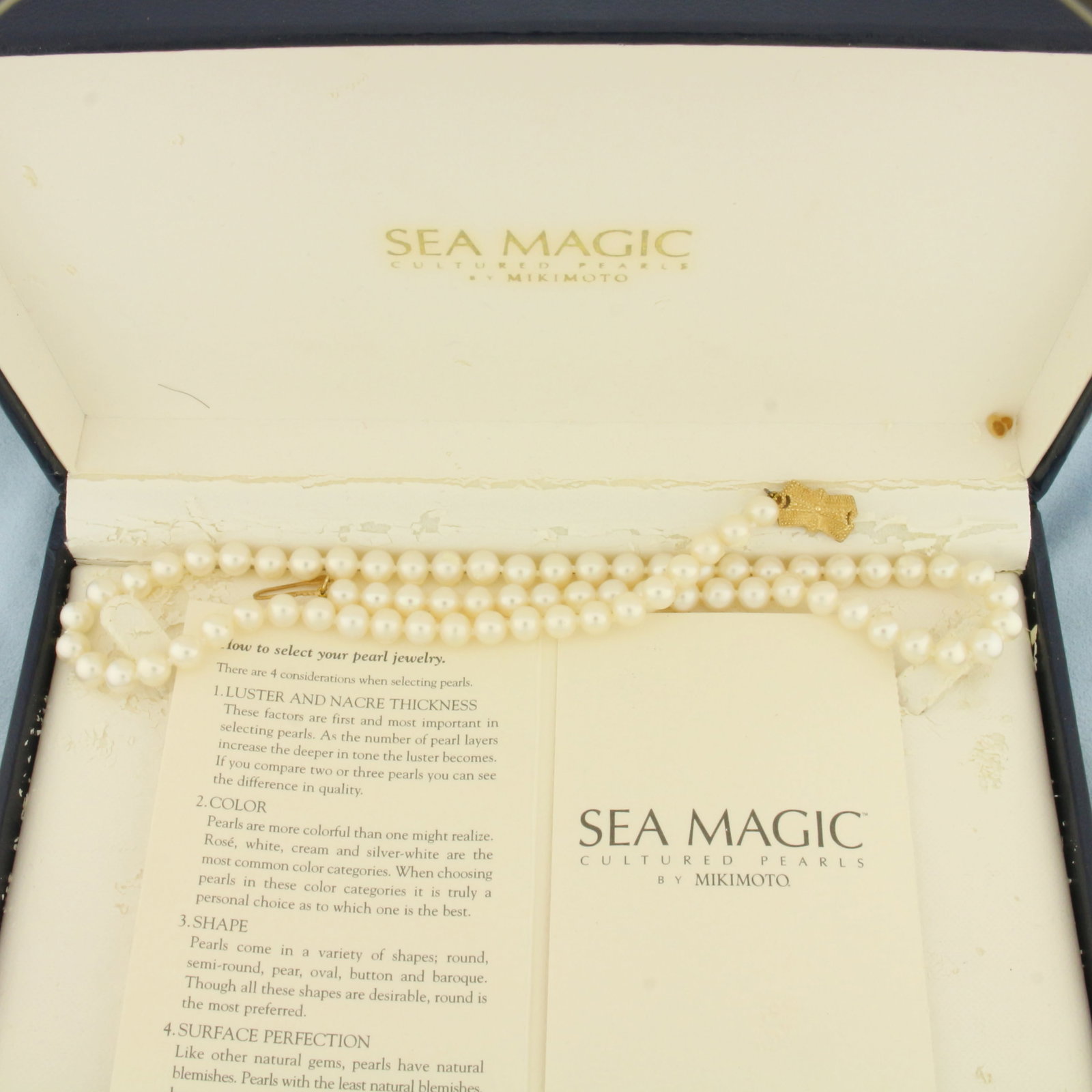 Mikimoto Cultured Akoya Pearl Necklace in 14K Yellow Gold: Clasp is 14k yellow gold. Hand knotted Mikimoto Sea Magic pearls. 18 inches long. Contains 6mm Cultured Akoya Pearls with high luster. Decorative locking clasp. Box and pamphlet included.