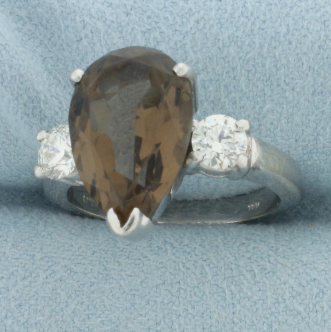 Smoky Quartz and Hearts on Fire Diamond Ring in 18k White Gold: In 18k white gold. Contains one 15 x 10mm pear cut smoky quartz gemstone, 4.5cts, with intense color and excellent clarity. Accented by 2 round brilliant "Hearts on Fire" diamonds (ideal cut), .6ct TW
