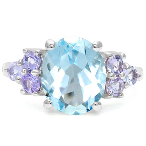 Huge Blue Topaz and Tanzanite Statement Ring in Sterling Silver: In platinum over .925 sterling silver. Contains one 4.3ct blue tanzanite gemstone accented with six tanzanite gems, 0.3ctw. Size 6. 3.5g