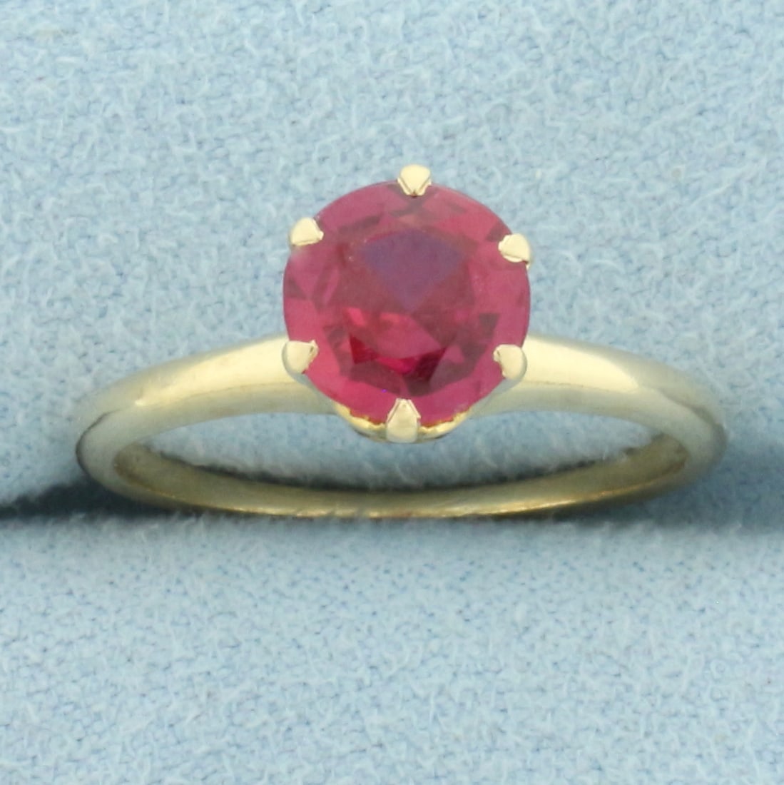 Pink Sapphire Solitaire Ring in 14k Yellow Gold: In 14k yellow gold. Contains one high quality 7.3mm Pink Sapphire gemstone, approximately 1.5ct, with vibrant color and excellent clarity. Size: 7.5. 3.0g.