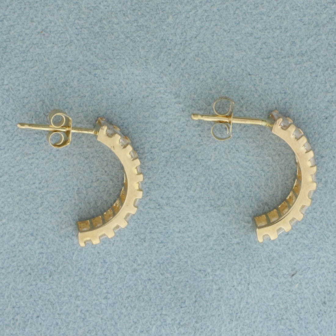 Baguette CZ Half Hoop Earrings in 14k Yellow Gold: In 14k Yellow Gold. Contains twenty high quality 4.5mm baguette CZ gemstone with excellent cut and clarity. 5/8 inch long. Friction backs. 2.4g.