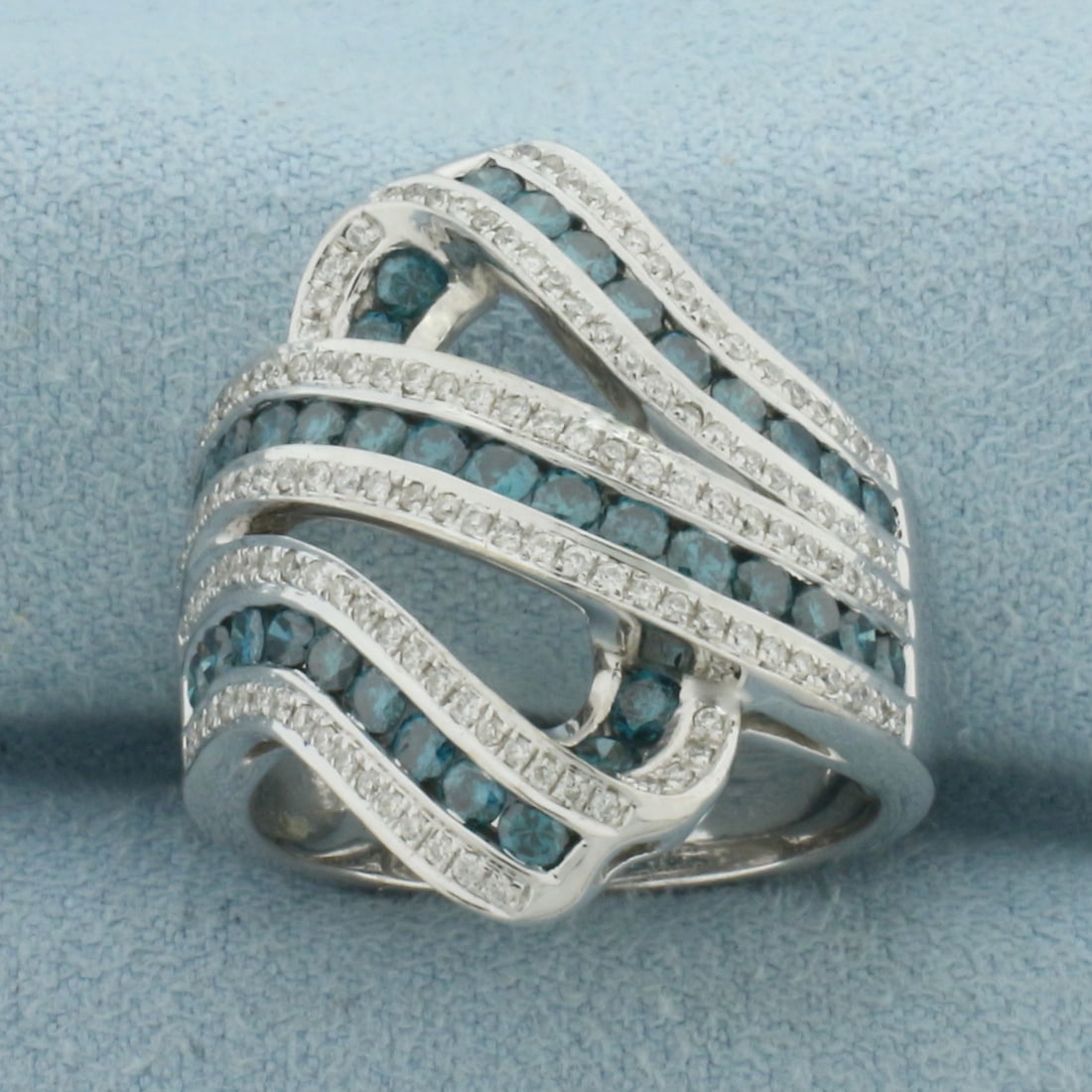 Blue and White Diamond Swirl Ring in 14K White Gold: In 14k white gold. 24mm wide at top of ring. Contains 38 high quality .03ct blue diamonds with intense color. Also contains 126 high quality 1/2pt "white" diamonds. Size 8. 10.1g.