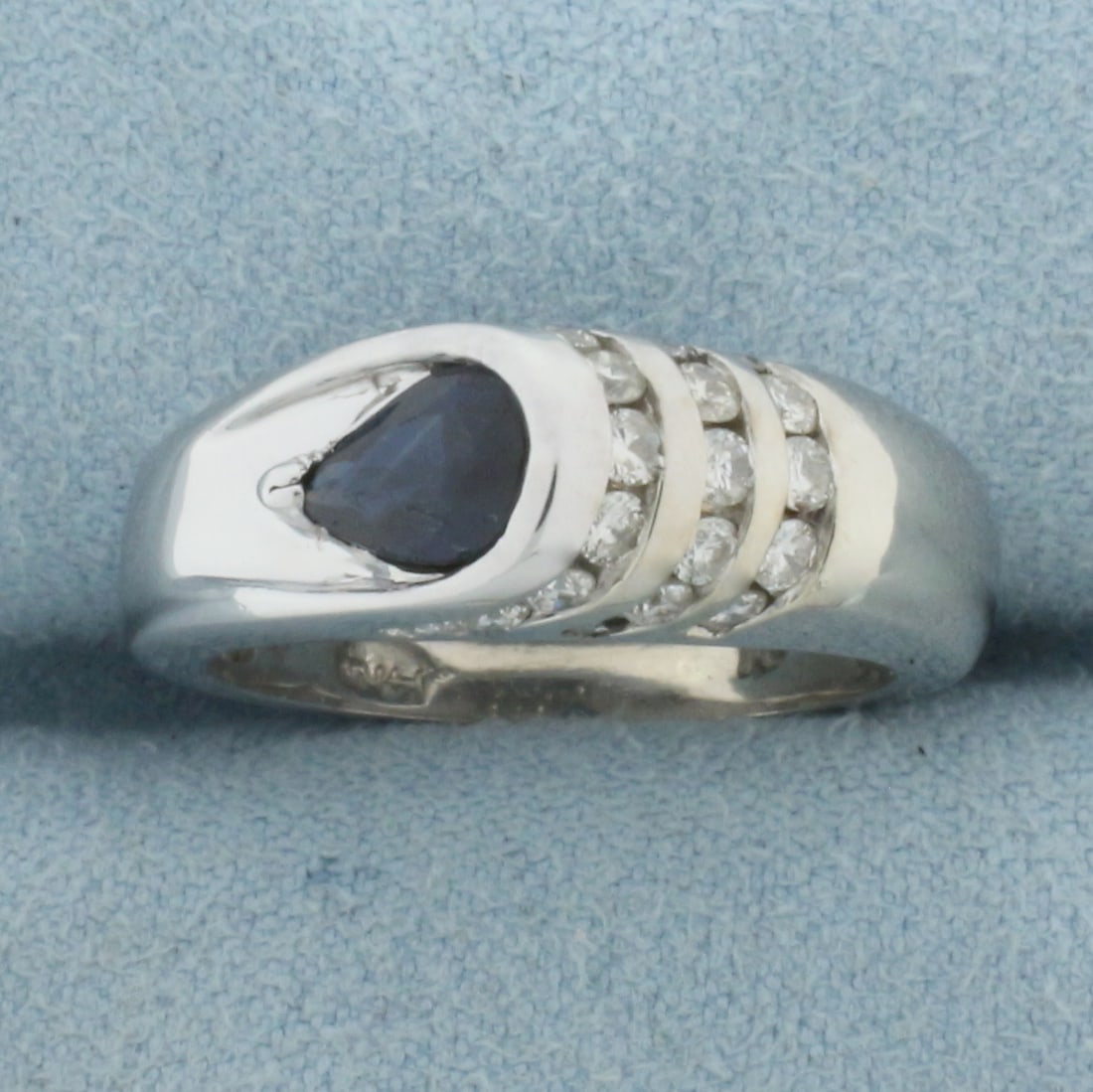 Modern Designer Sapphire and Diamond Ring in 14k White Gold: In 14k White Gold. Contains one 7x5mm high quality natural Sapphire gemstone, approximately .75cts, with deep color and excellent clarity. Also contains twenty-one .02ct high quality diamonds, SI clar