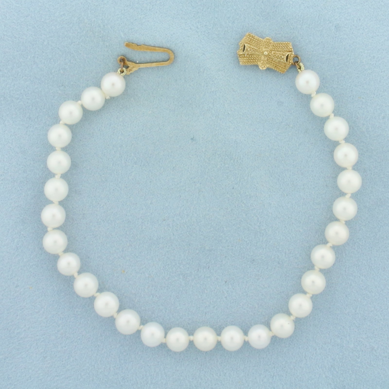 Mikimoto Cultured Akoya Pearl Bracelet in 14K Yellow Gold: Clasp is 14k yellow gold. Hand knotted Mikimoto Sea Magic pearls. 8.25 inches long. Contains 6mm Cultured Akoya Pearls with high luster. Decorative locking clasp.