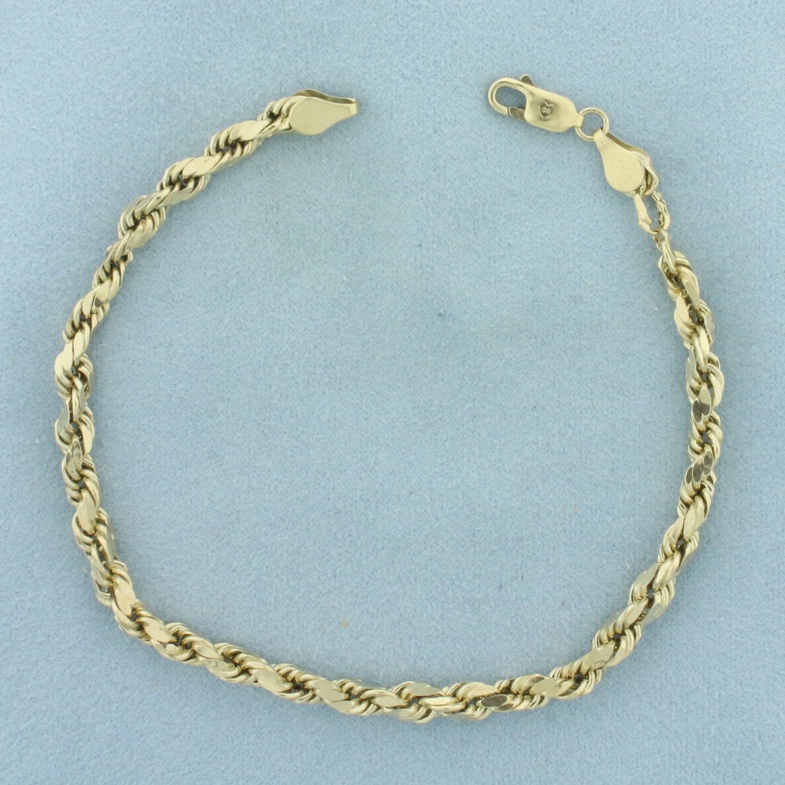 Mens Diamond Cut Rope Link Bracelet in 14K Yellow Gold: In 14k yellow gold. 8 7/8 inches long by 4mm wide. Lobster clasp. 5.3g.