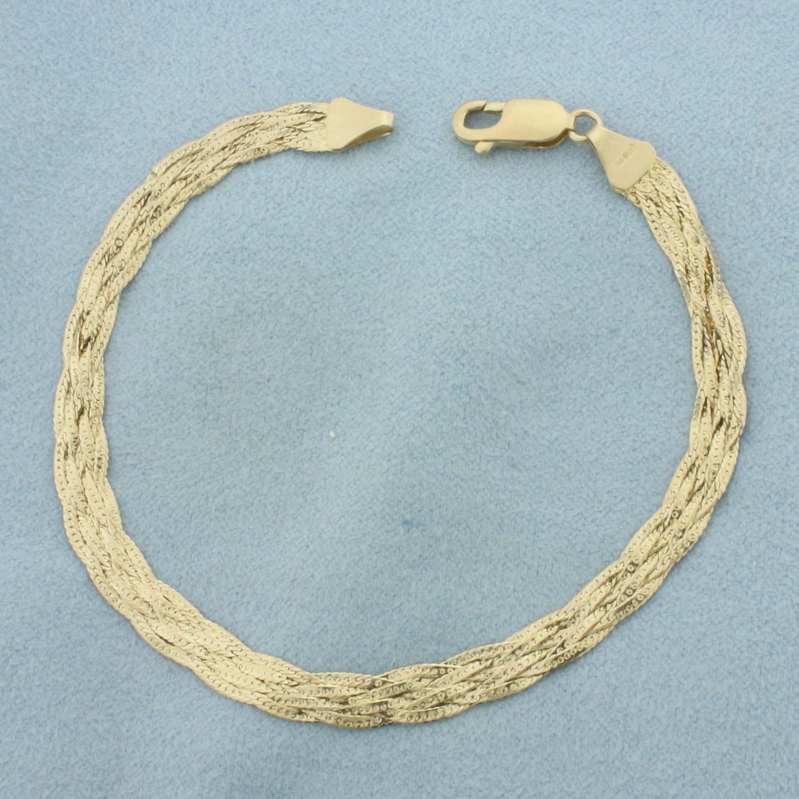 Italian Braided Herringbone Link Bracelet in 14K Yellow Gold: In 14k yellow gold. Italian made. 7 1/8 inches long by 1/4 inch wide with lobster clasp. 3.4g.