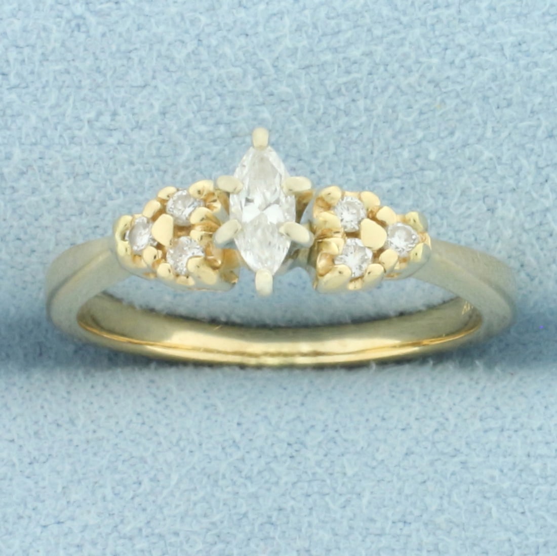 Marquise Diamond Accented Engagement Ring in 14k Yellow Gold: In 14k yellow gold. Contains one high quality 1/4ct marquise diamond, SI1 clarity/I color, eye clean, great cut. Also contains six high quality round brilliant .01ct diamonds of similar high quality. 
