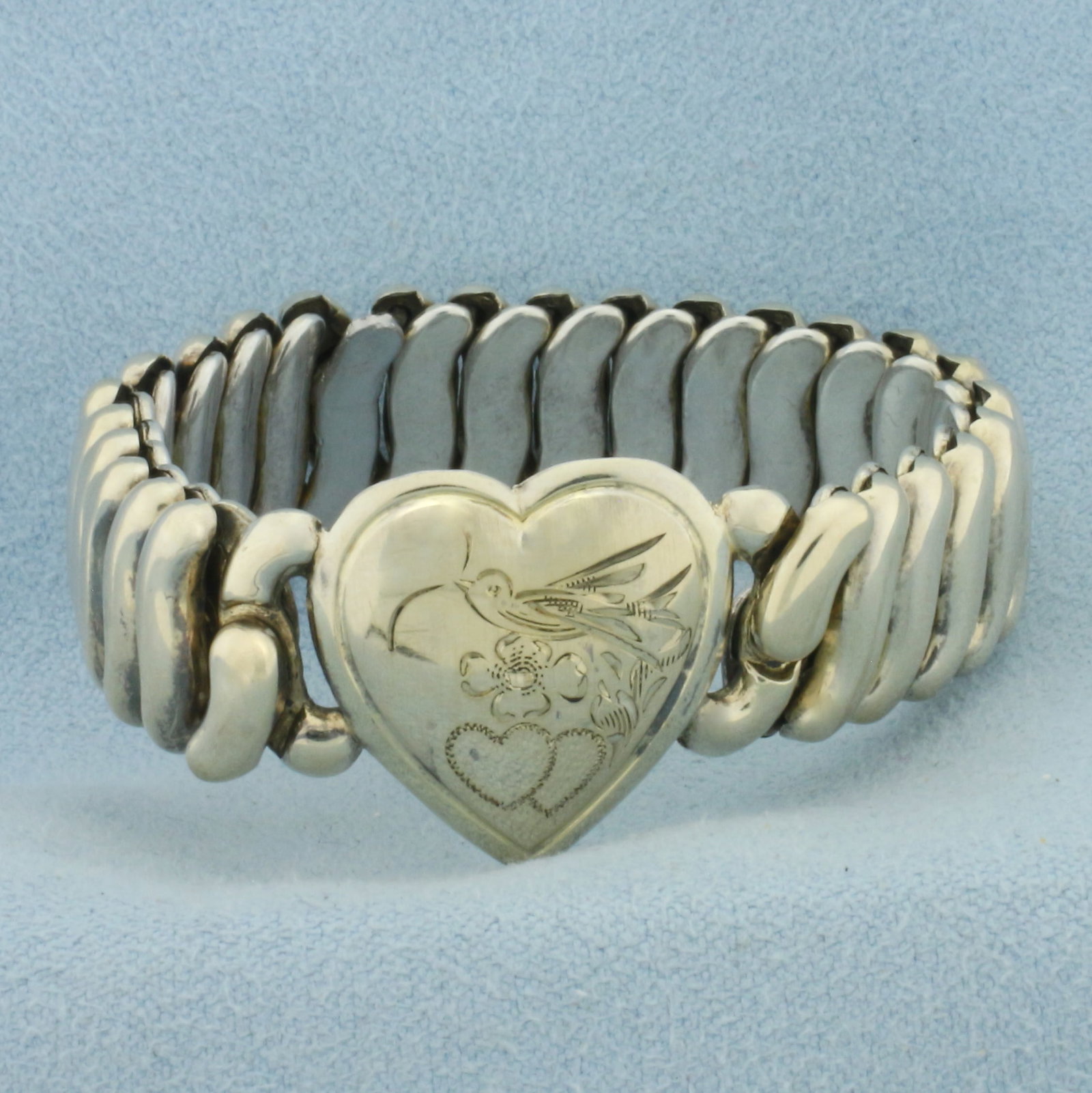 Vintage Baby Child Bird Flower and Heart Strech Bracelet in Sterling Silver: Center heart is .925 sterling silver and stretch band is base metal. 4 3/4 inches circumference. Heart is 20.5mm long.