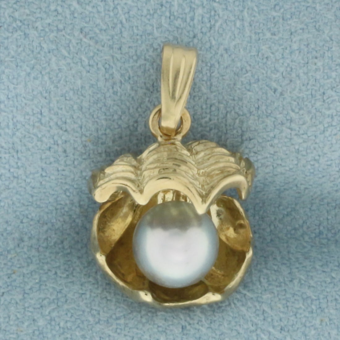 Tahitian Pearl in Oyster Shell 3D Pendant in 10K Yellow Gold: In 10k yellow gold. 3/4 inch long (including bail) by 1/2 inch wide. Contains 1 high quality natural 7.2mm Tahitian Pearl with high luster. 3.1g.