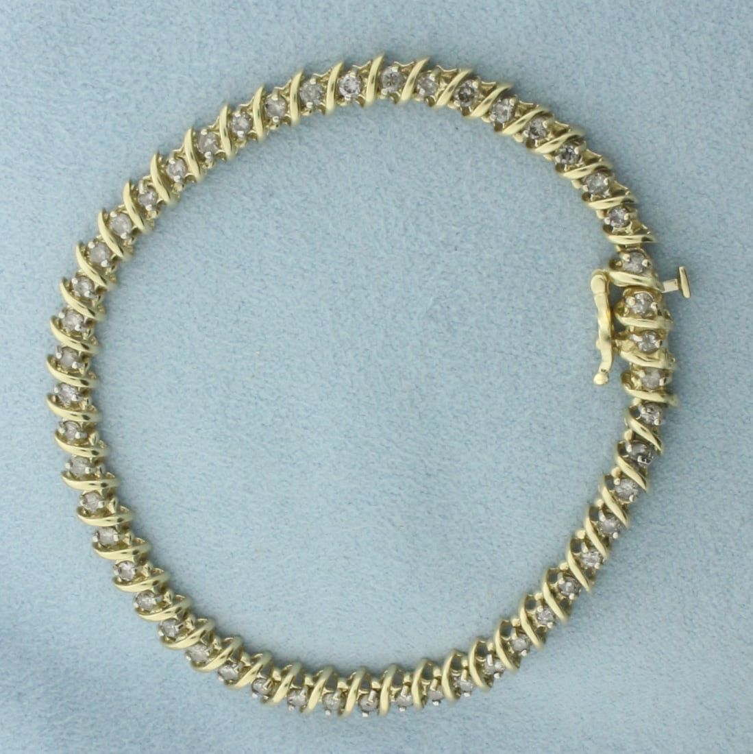 Diamond Tennis Bracelet in 10K Yellow Gold: In 10k yellow gold. 7 3/8 inches long by 5mm wide. Contains 50 high quality natural diamonds, 2ct TW. Concealed slide clasp with safety latch. 9.2g.