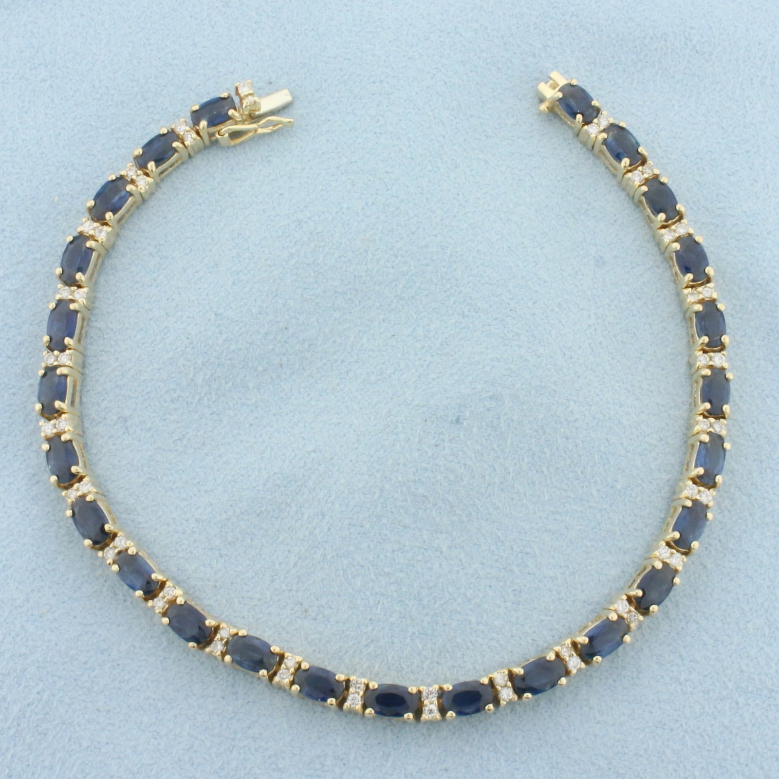 Sapphire and Diamond Tennis Bracelet in 14k Yellow Gold: In 14k Yellow Gold. Contains twenty-five high quality natural 5mm Sapphire gemstones, approximately 6.25ct TW, with deep blue color and excellent clarity. Also contains fifty .01ct diamonds, SI