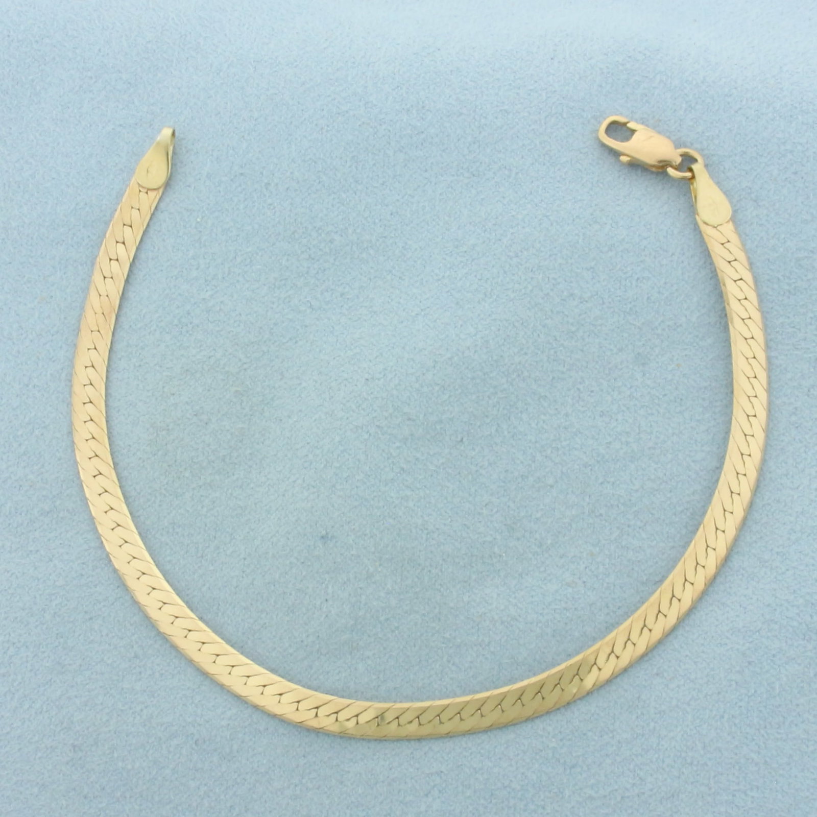 Herringbone Link Bracelet in 14K Yellow Gold: In 14k yellow gold. 7 5/8 inch long by 4.1mm wide, with lobster clasp. 5.7g.