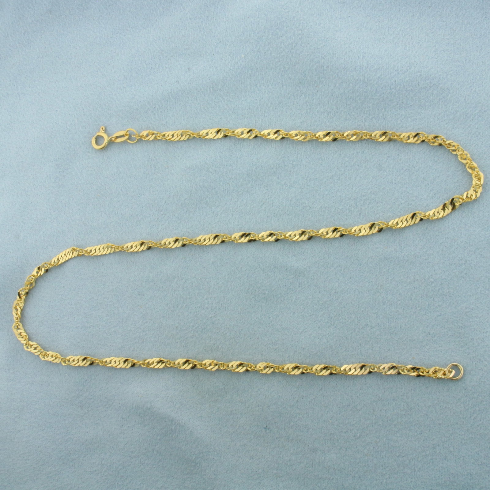 16 Inch Twisting Curb Link Chain Necklace In 21K Yellow Gold: In 21k yellow gold. 16 inches long by 3mm wide. Spring clasp. 6.8g.