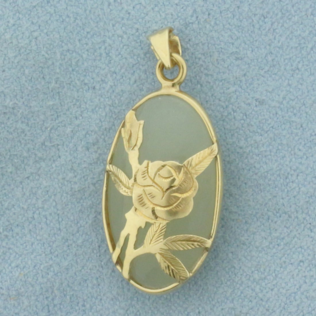 Jade Flower Pendant in 14K Yellow Gold: In 14k yellow gold. Contains 1 high quality natural Jade gemstone with bright color. 1 1/8 inch long (including bail) by 1/2 inch wide. 2.6g.