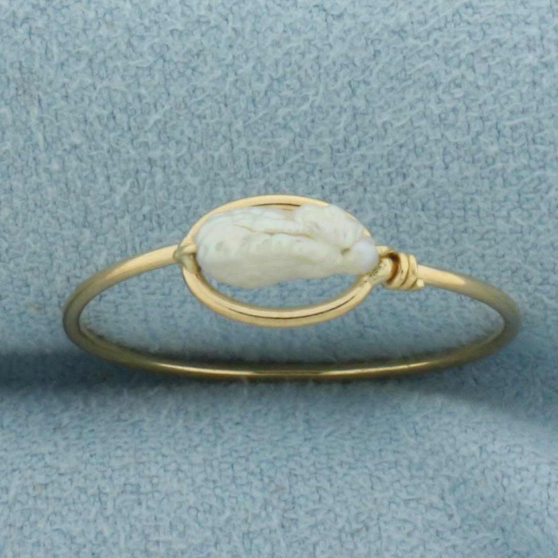 Freshwater Baroque Pearl Ring in 18K Yellow Gold: In 18k yellow gold. 5.8mm wide at center. Freshwater 9x3mm Pearl with high luster. Size 8. .8g.