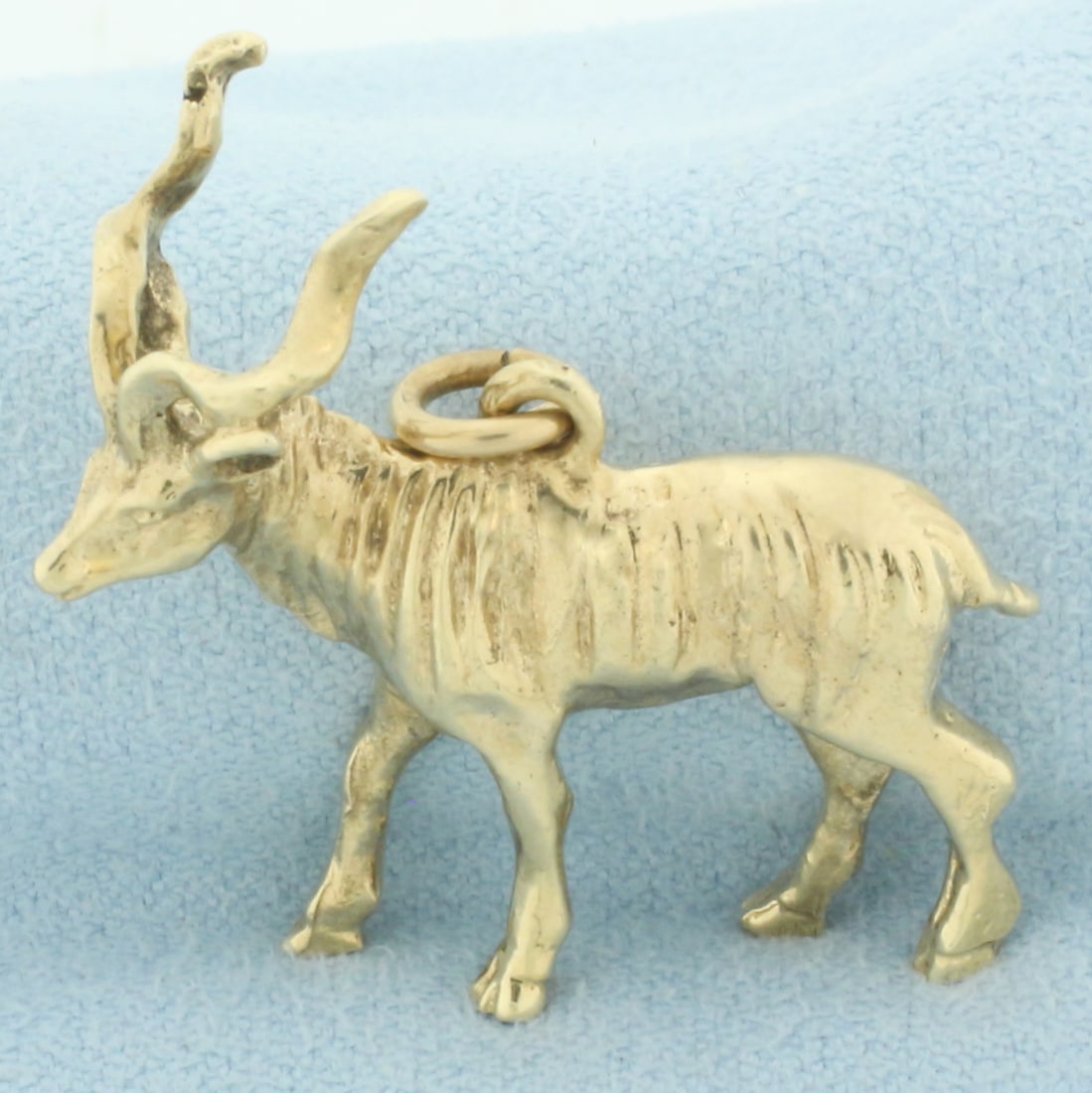 Greater Kudu Charm or Pendant in 14k Yellow Gold: In 14k yellow gold. 1 1/8 inches long and 1 1/8 inches wide. 9.2g.