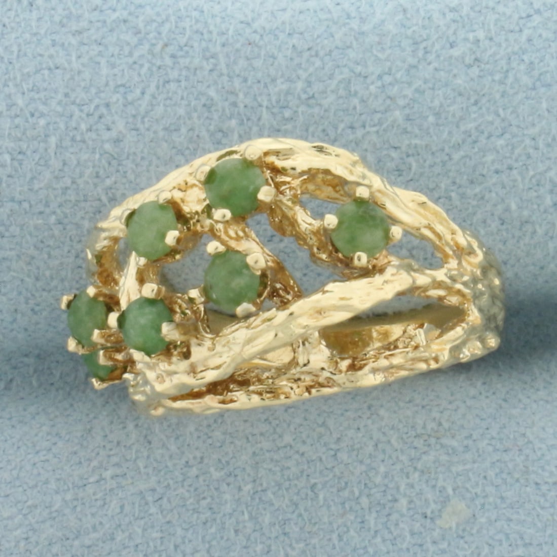 Jade Nature Branch Ring in 14k Yellow Gold: In 14k Yellow Gold. Contains seven 3mm high quality natural Jade gemstones. 13mm wide at center of ring. Size 6.75. 6.9g.