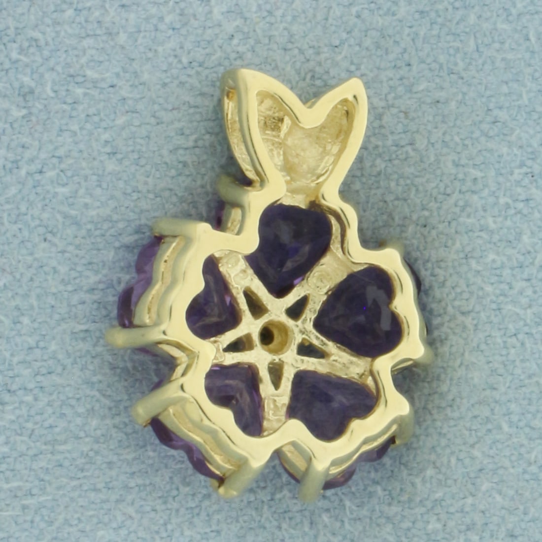 Heart Cut Amethyst and Diamond Clover Pendant in 14k Yellow Gold: In 14k Yellow Gold. Contains five 6mm high quality heart cut natural Amethyst gemstones with vibrant color and excellent clarity. Also contains one .01ct high quality diamond. 3/4 inch long. 5/8 inch 