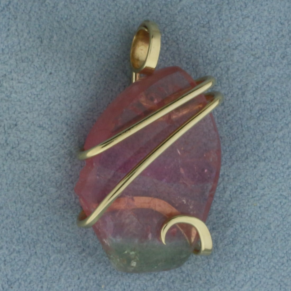 Watermelon Tourmaline Pendant in 14k Yellow Gold: In 14k yellow gold. 1 1/8 inch long (including bail) by 5/8 inch wide. Contains one 7/8 inch by 5/8 inch Watermelon Tourmaline gemstone with bright color.
