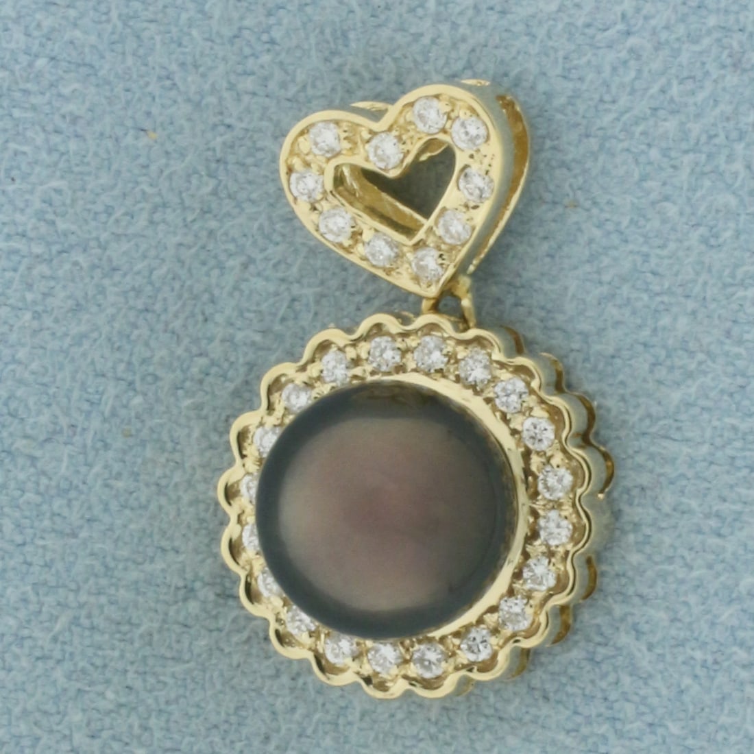Tahitian Pearl and Diamond Heart Pendant in 14K Yellow Gold: In 14k yellow gold. 3/4 inch long by 1/2 inch wide. Contains one 9mm Tahitian Pearl with high luster. Also contains 30 high quality natural .01ct diamonds, SI clarity/G color. 4.5g.