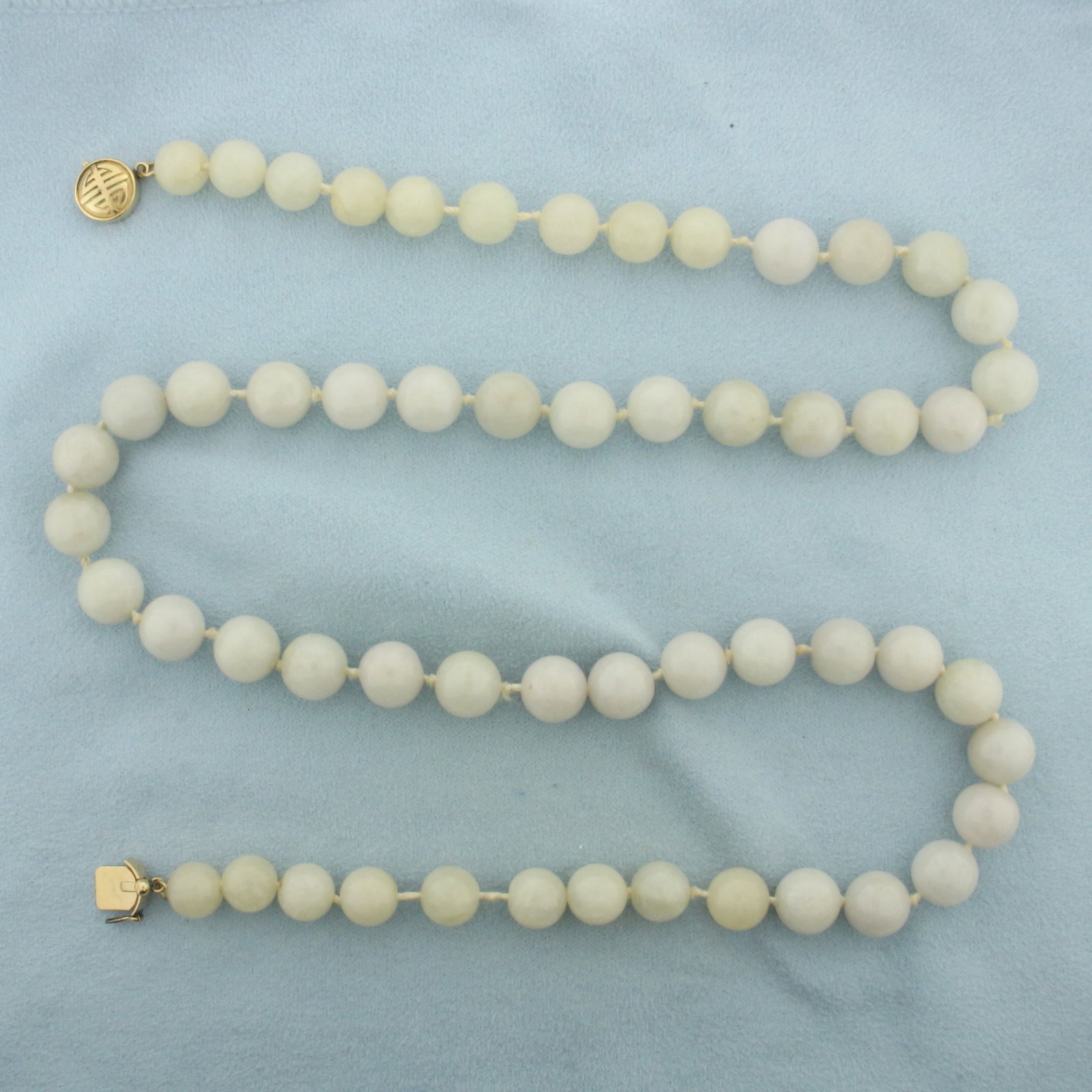 Gump's 10mm White Jade Necklace in 14K Yellow Gold: In 14k yellow gold. Hand knotted 10mm high quality White Jade gemstones. 24 inches long with decorative slide clasp and safety latch. Retails for $2,250 on Gump's website. 87.5g.