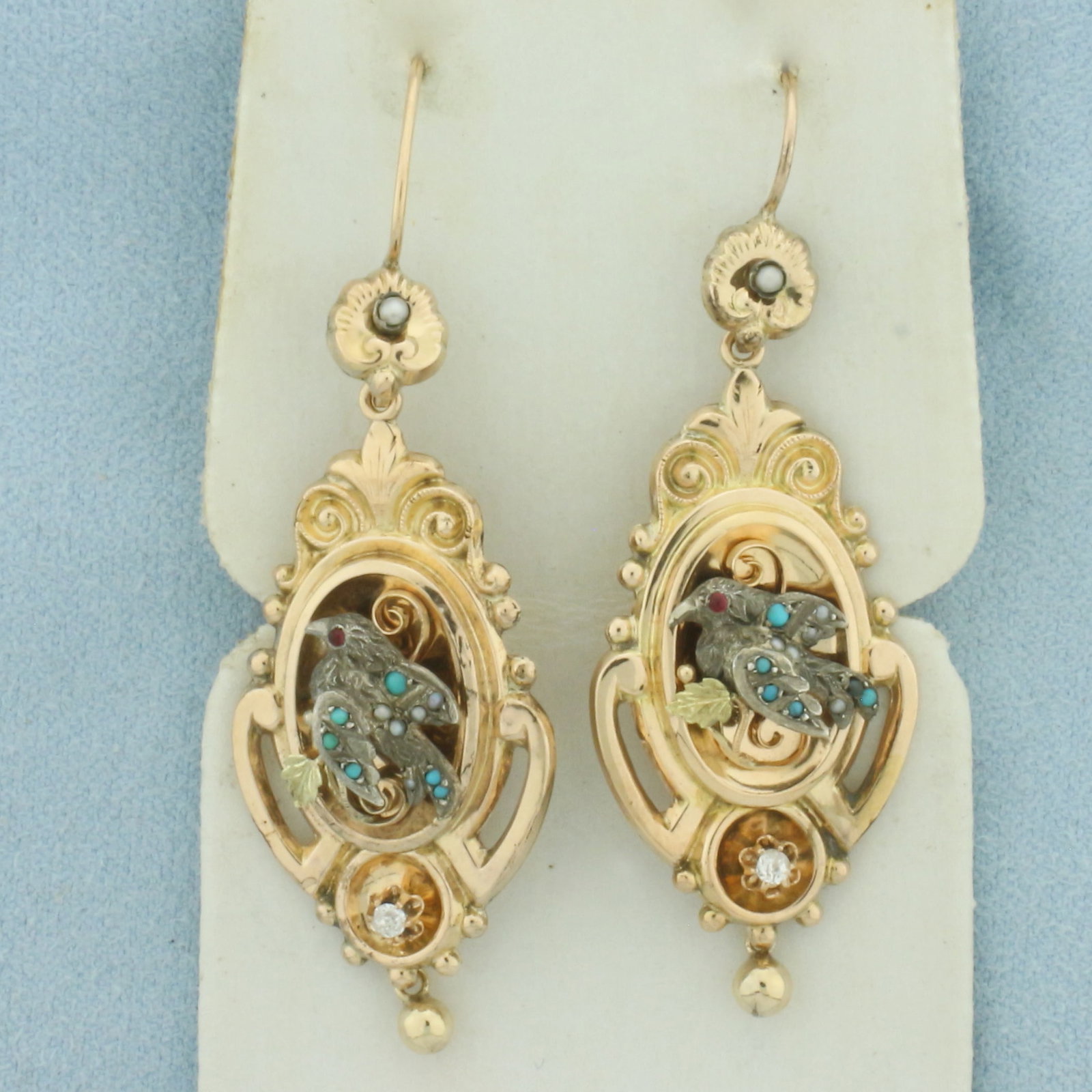 Antique Victorian Georgian Old Mine Diamond Turquoise Ruby Bird Earrings in 14k Yellow Gold: In 14k yellow gold with .925 sterling silver accents. 2 1/4 inches long by 5/8 inches wide. Contains two high quality .03ct Antique Old Mine Cut Natural Diamonds. Accented with high quality Seed Pearl