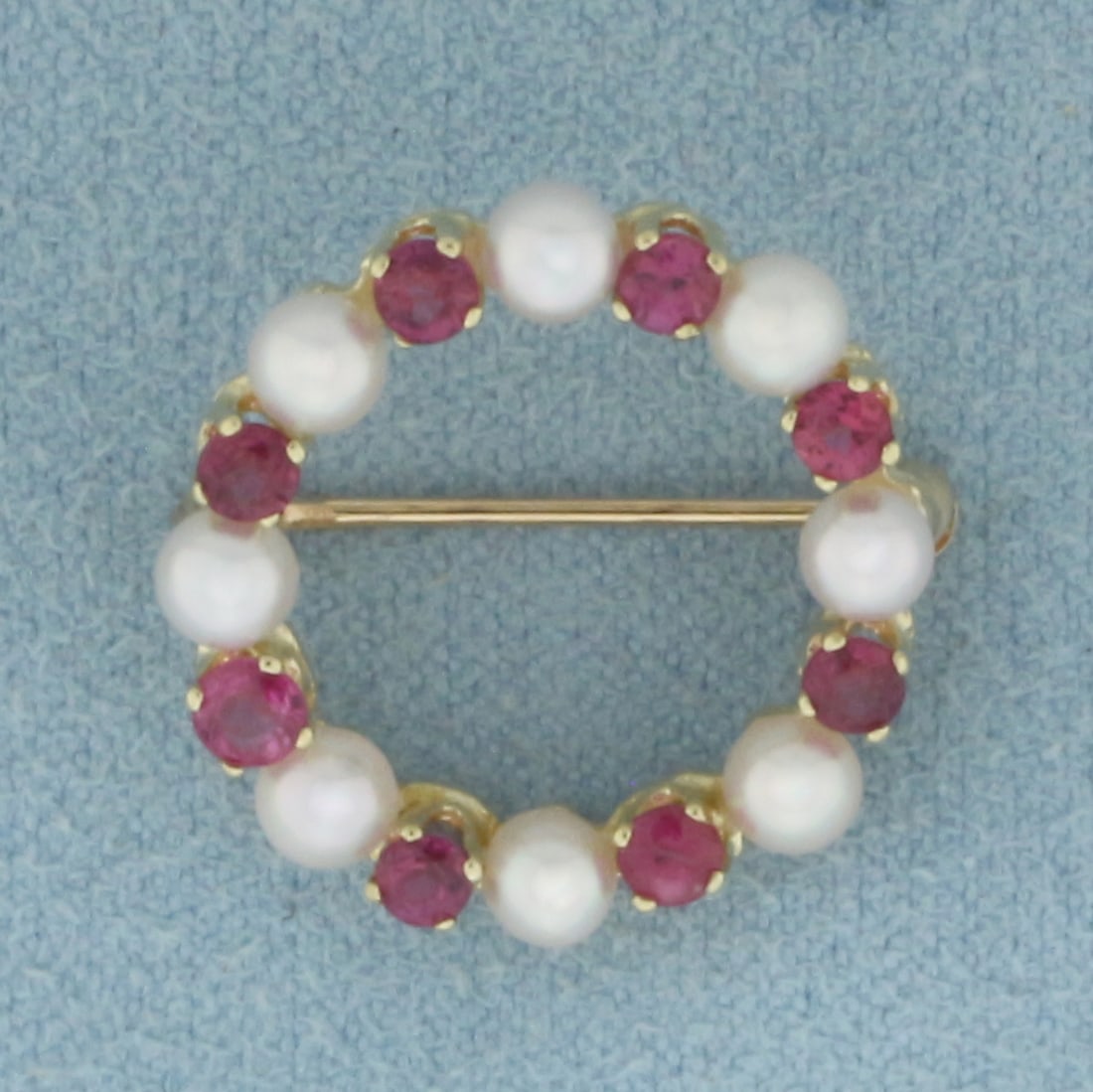 Ruby and Cultured Akoya Pearl circle Brooch Pin in 14K Yellow Gold: In 14k yellow gold. 3/4 inch diameter. Contains 8 high quality 3.3mm Cultured Pearls with high luster. Also contains eight high quality natural vibrant 2.5mm Ruby gemstones. 2.3g.