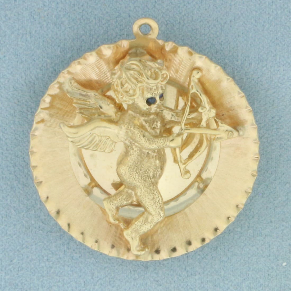 Large Cupid 3D Medallion Charm or Pendant in 14k Yellow Gold: In 14k yellow gold. 1.5 inches long by 1 3/8 inches wide. Contains 2 natural high quality 1mm Sapphire gemstones and 1 high quality 6.8mm Cultured Akoya Pearl. 13.5g.