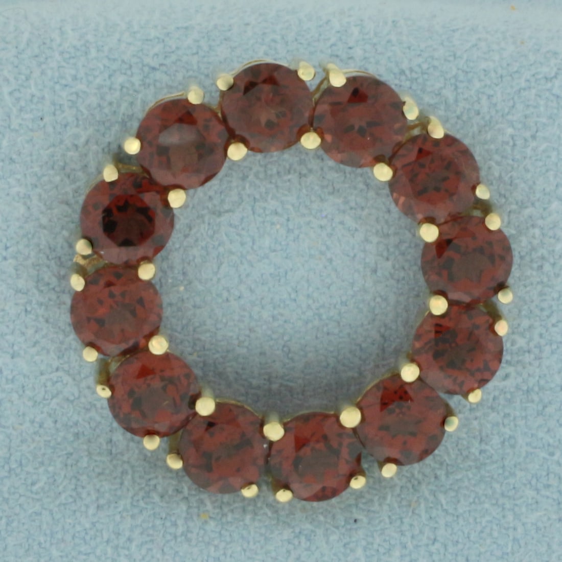 Garnet Circle Pendant in 10K Yellow Gold: In 10k yellow gold. 1 inch diameter. Contains 12 high quality natural 5mm Garnet gemstones, with vibrant color and excellent clarity. 4.6g.
