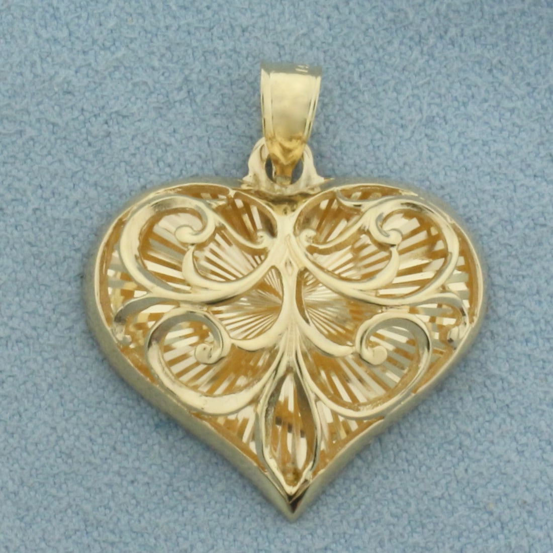 Filigree Heart Pendant in 14K Yellow Gold: In 14k yellow gold. 1 inch long (including bail) by 7/8 inch wide. 4.4g.