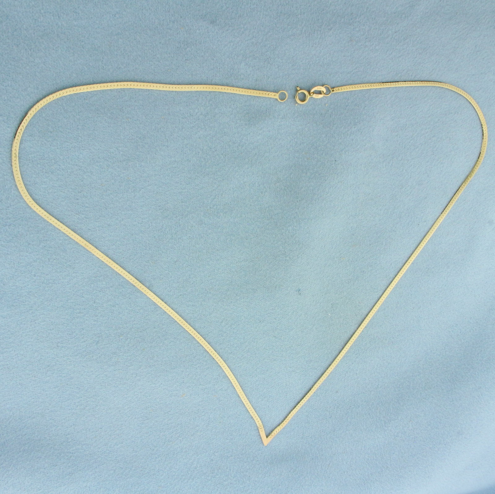 16 Inch Herringbone Link V Necklace in 14K Yellow Gold: In 14k yellow gold. 16 inches long by 1.6mm wide, with spring clasp. 2.3g.