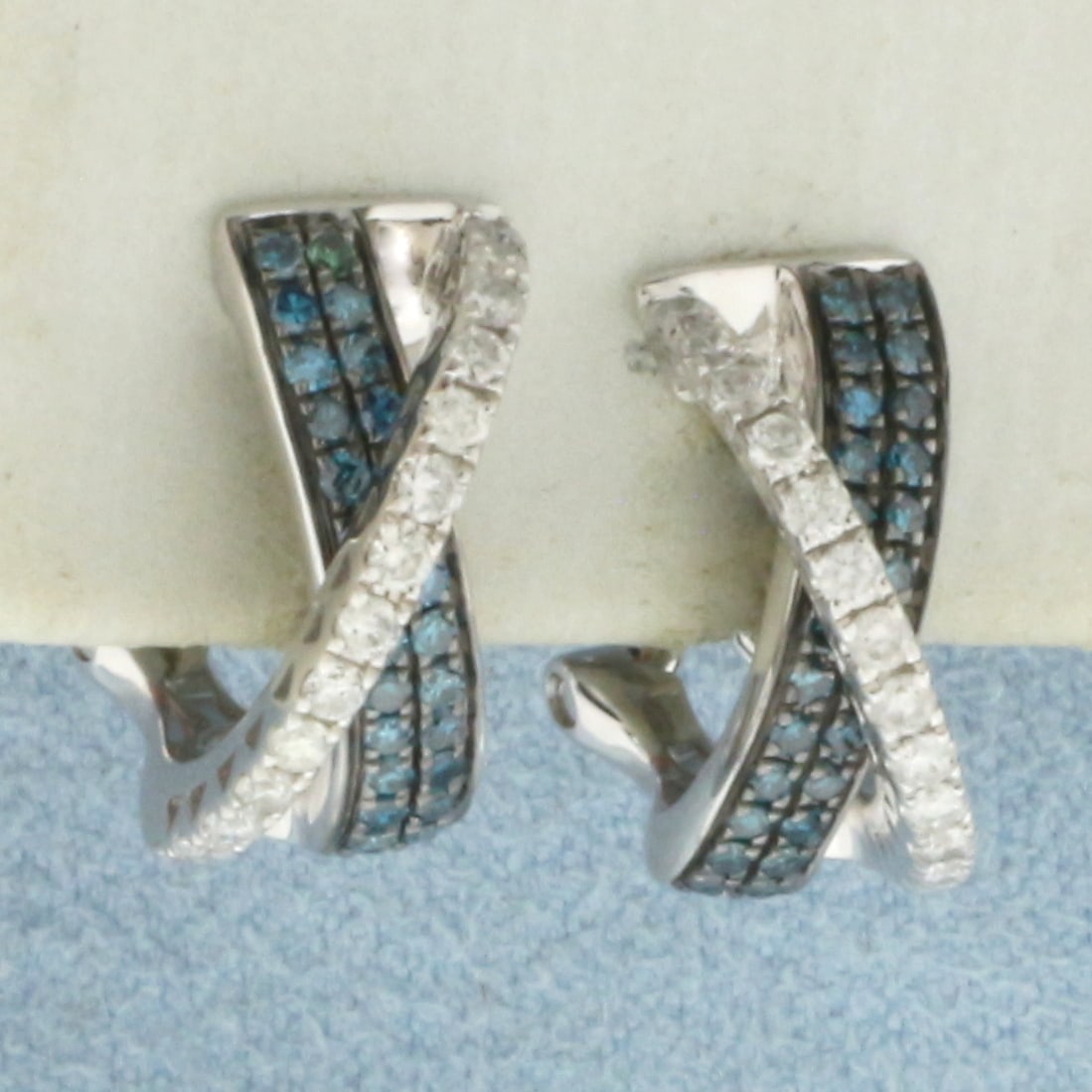 Blue and White Diamond Earrings in 14K White Gold: In 14k white gold. 1/2 inch long by 3/8 inch wide. Contains 28 natural high quality .01ct "white" diamonds. Also contains 26 high quality natural 1/2pt Blue Diamonds. Omega backs for added comfort. 4.